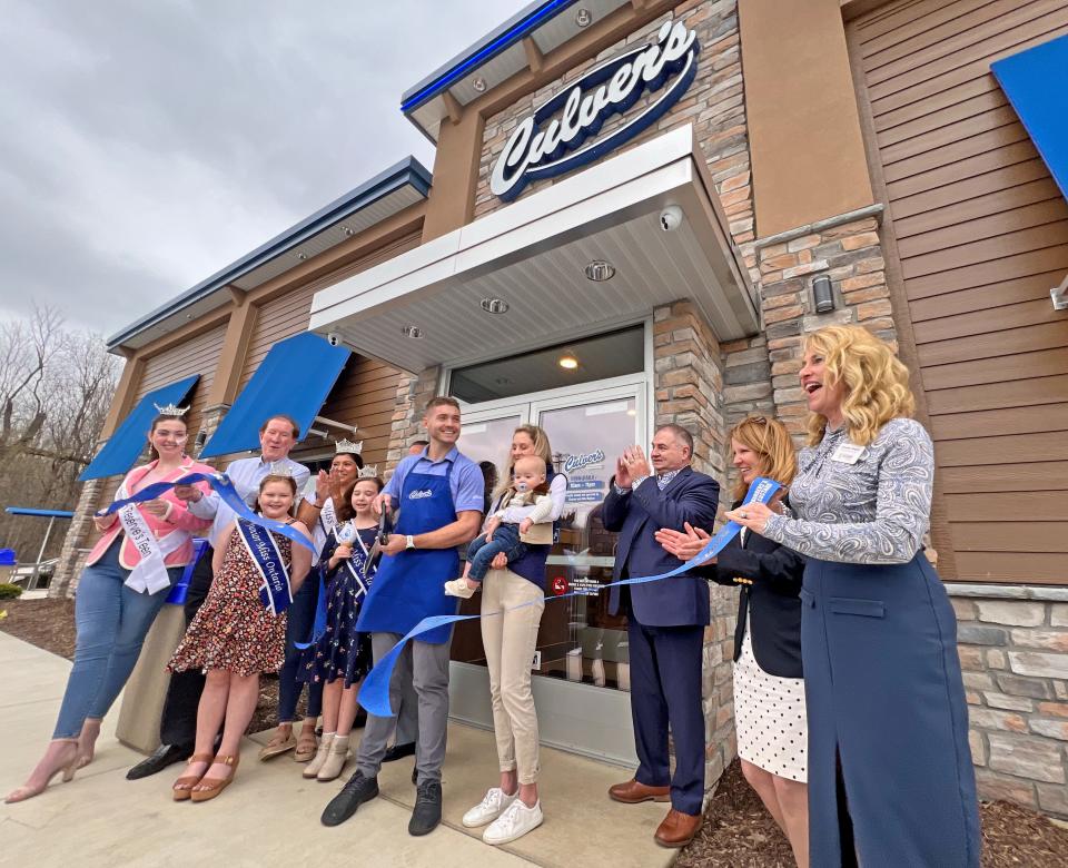 Chanse Meylan, owner of the new Culver's in Ontario, cuts the ribbon Wednesday mornig outside the newest burger spot in the area.