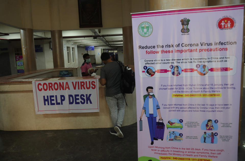 A man is seen filling an application with symptoms at coronavirus help desk at the Government Gandhi Hospital in Hyderabad.