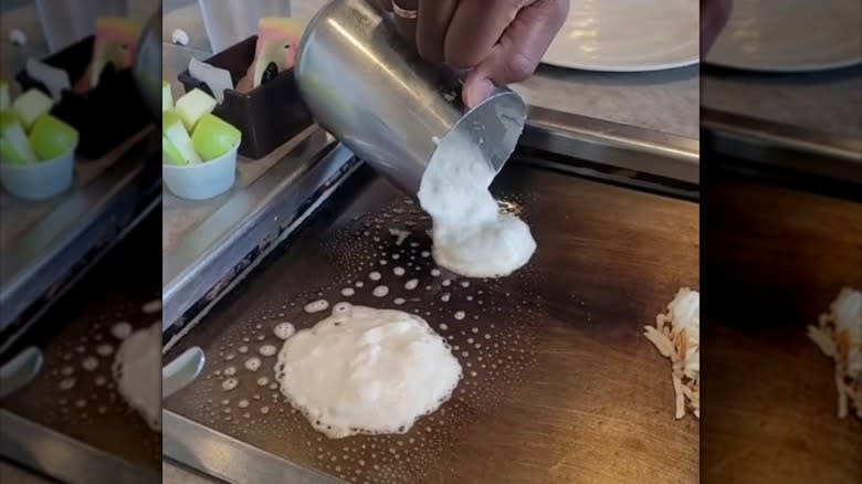 Person pouring batter on griddle