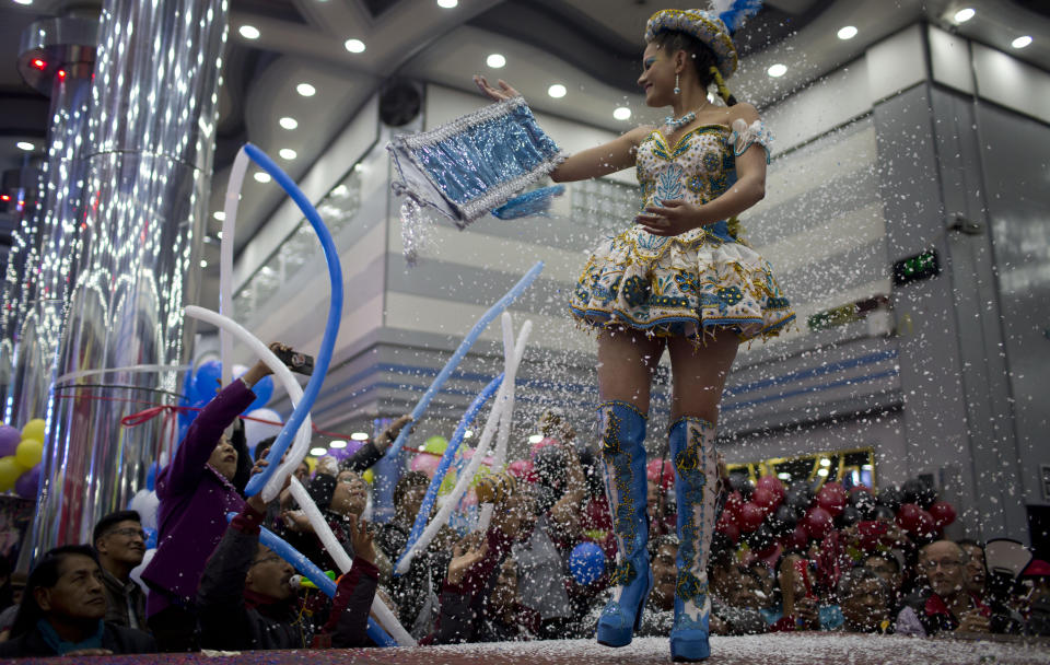 A contestant competes in the Queen of Great Power contest, in La Paz, Bolivia, Friday, May 24, 2019. The largest religious festival in the Andes choses its queen in a tight contest to head the Festival of the Lord Jesus of the Great Power, mobilizing thousands of dancers and more than 4,000 musicians into the streets of La Paz. (AP Photo/Juan Karita)