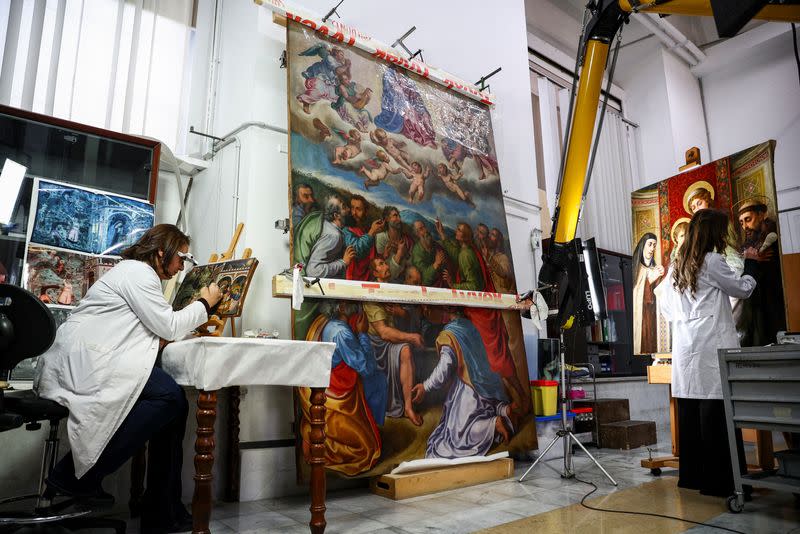Art restorers work at the "painting and wood materials restoration laboratory" in the Vatican Museums, at the Vatican