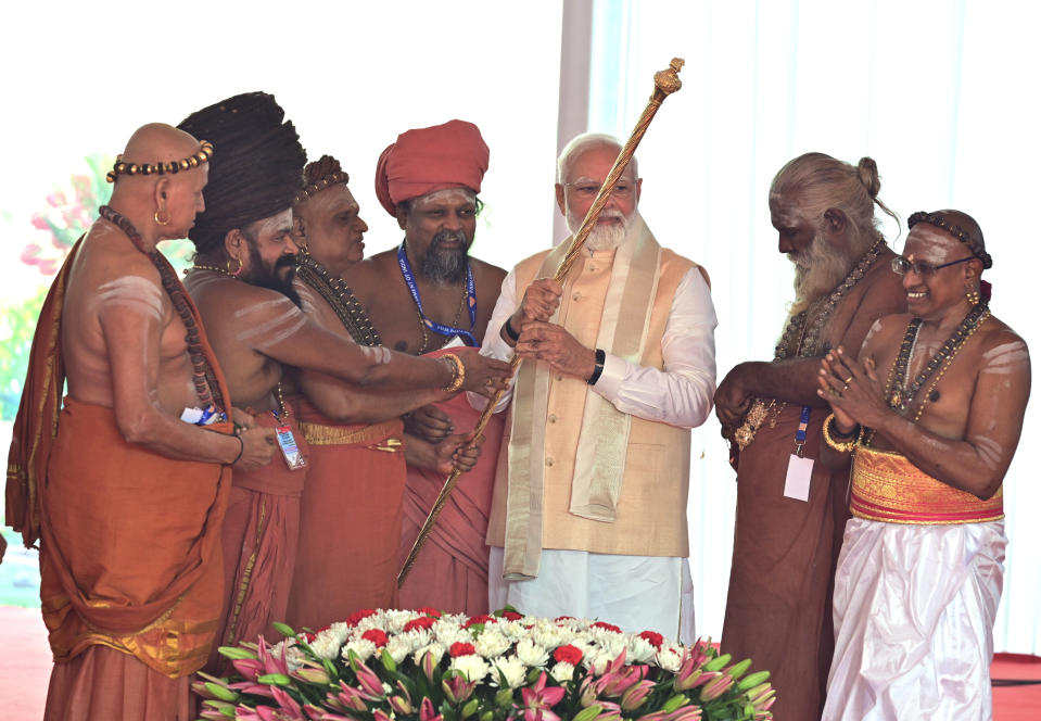 Hindu priests hand over a royal golden sceptre to Indian prime minister Narendra Modi to be installed near the chair of the speaker during the start of the inaugural ceremony of the new parliament building, in New Delhi, India, Sunday, 28 May 2023. The new triangular parliament building, built at an estimated cost of $120 million, is part of a $2.8 billion revamp of British-era offices and residences in central New Delhi called "Central Vista", even as India's major opposition parties boycotted the inauguration, in a rare show of unity against the Hindu nationalist ruling party that has completed nine years in power and is seeking a third term in crucial general elections next year. (AP Photo)