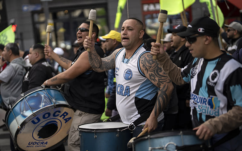 Construction union members in Buenos Ares, Argentina, beat on drums during a protest