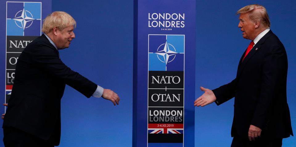 Britain's Prime Minister Boris Johnson (L) greets US President Donald Trump upon arrival for the NATO summit. Photo: ADRIAN DENNIS/AFP via Getty Images