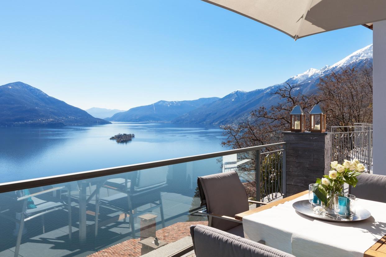 terrace of house with dining table and lake view