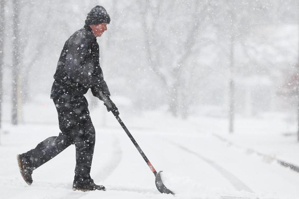 Tom Ingram works to clear snow from the street near the driveway of LTR Diesel on Indiana Avenue in Lexington, Ky., Thursday, Jan. 6.