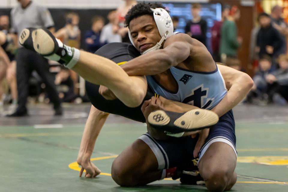 Don Lindsey (blue) looks to change positions on Jacob Chacon (Black) during the WPIAL Class 2A Northern Section Tournament at Keystone Oaks High School.