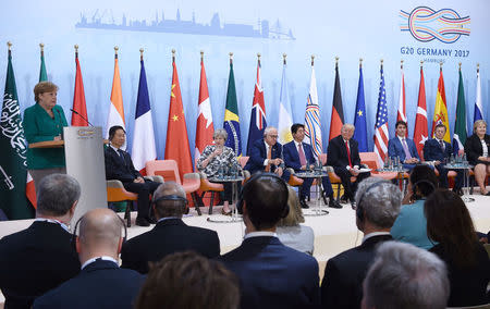 German Chancellor Angela Merkel (L) speaks during the panel discussion "Launch Event Women's Entrepreneur Finance Initiative" on the second day of the G20 Summit in Hamburg, Germany, July 8, 2017. REUTERS/Patrik STOLLARZ/Pool