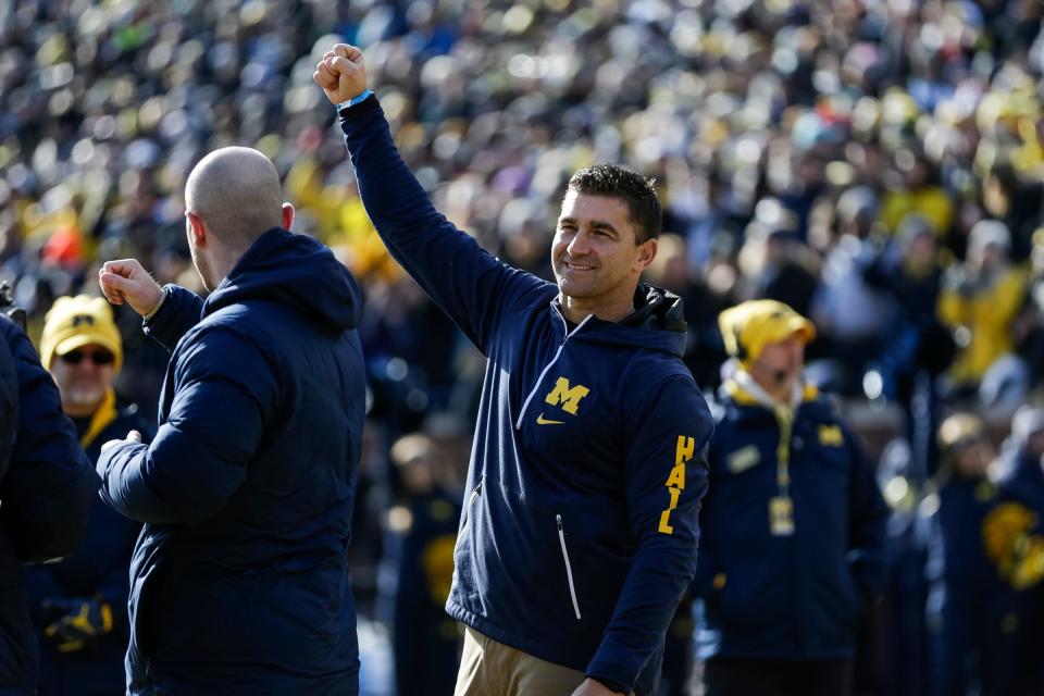 Michigan baseball coach Erik Bakich waves at the crowd during the football game against Michigan State at Michigan Stadium in Ann Arbor, Saturday, Nov. 16, 2019.