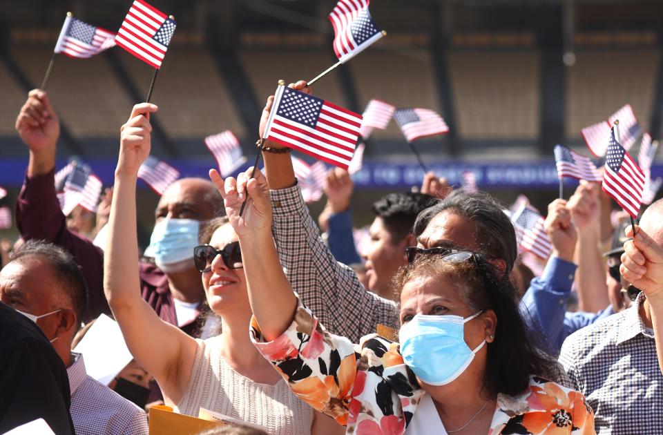 New U.S. citizens celebrate after being sworn in at a naturalization ceremony at Dodger Stadium on Aug. 29, 2022 in Los Angeles.