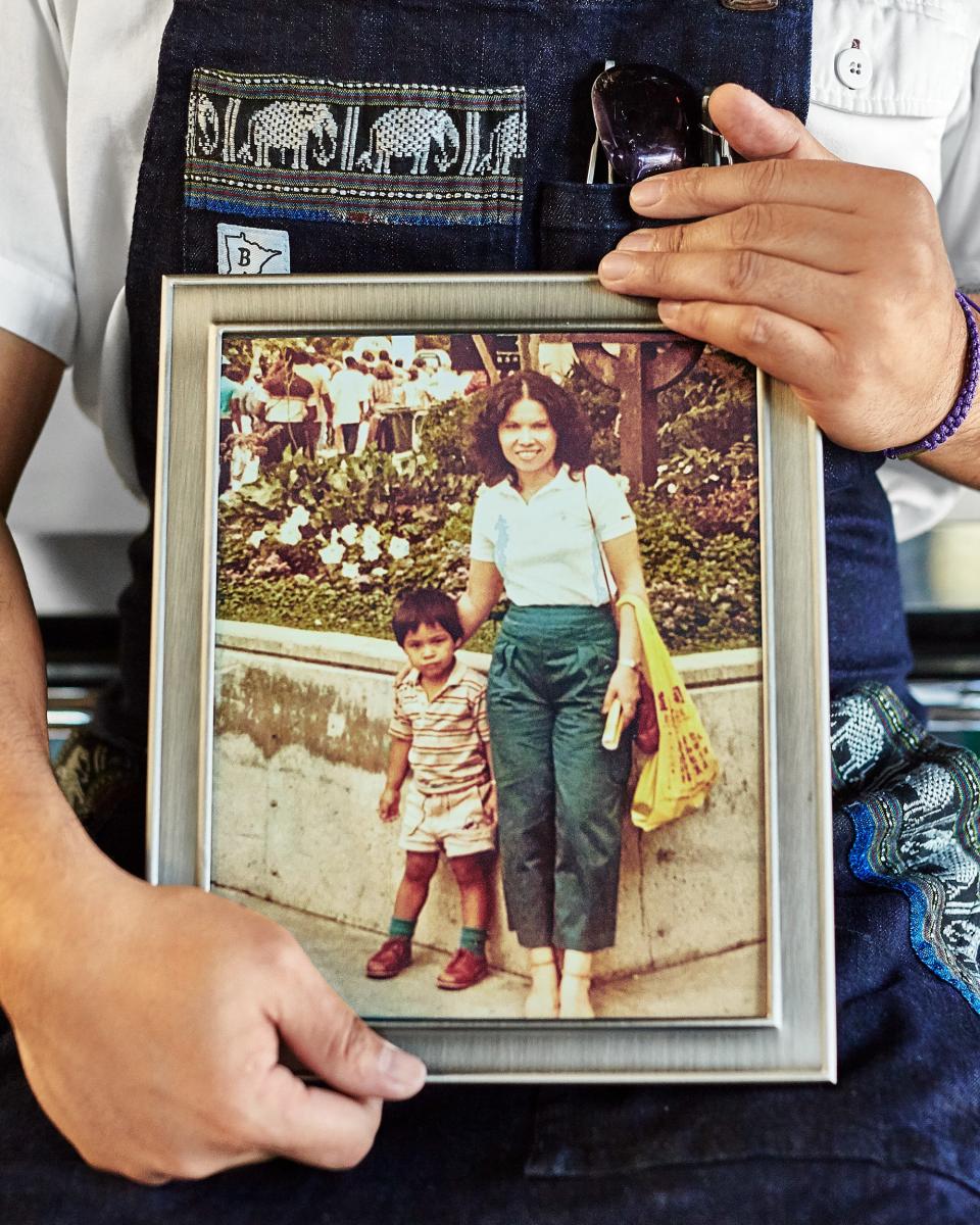 Donny Sirisavath holds a photo of himself and his mother, Phaysane.