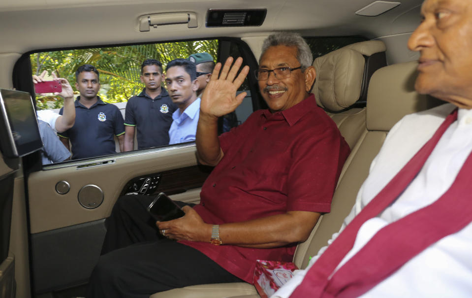 Sri Lanka's former Defense Secretary and presidential candidate Gotabaya Rajapaksa, waves to media as he leaves for the election commission from his residence in Colombo, Sri Lanka, Sunday, Nov.17, 2019. Rajapaksa, revered by Sri Lanka’s ethnic majority for his role in ending a bloody civil war but feared by minorities for his brutal approach, declared victory Sunday in the nation’s presidential election. (AP Photo/Lahiru Harshana)