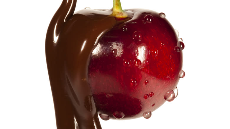 dripped chocolate over a red cherry