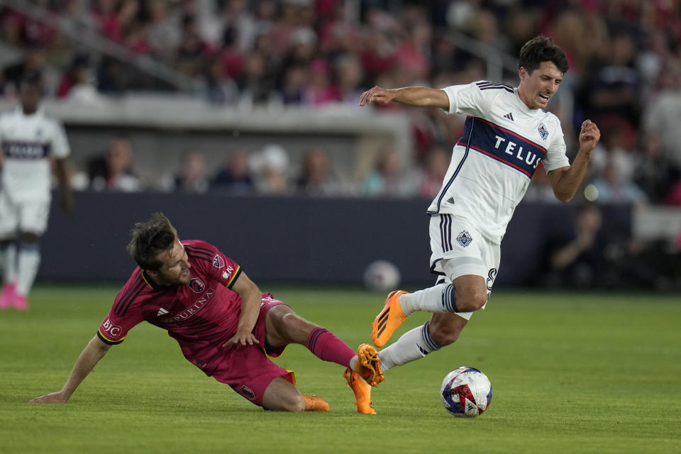 St. Louis City's Indiana Vassilev, left, tackles Vancouver Whitecaps' Alessandro Schopf during the second half of an MLS soccer match Saturday, May 27, 2023, in St. Louis. (AP Photo/Jeff Roberson)