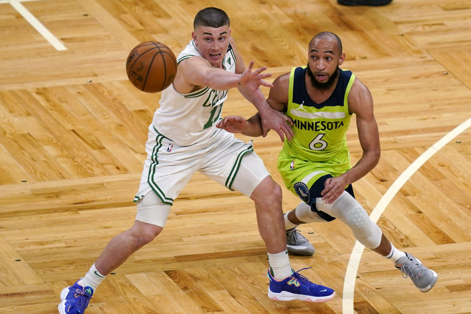 Boston Celtics guard Payton Pritchard (11) steals a pass intended for Minnesota Timberwolves guard Jordan McLaughlin (6) during the first quarter of an NBA basketball game Friday, April 9, 2021, in Boston. (AP Photo/Elise Amendola)