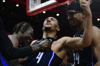 Orlando Magic's Jalen Suggs (4) celebrates with teammates Wendell Carter Jr (34) and Mo Bamba, left, after scoring the winning basket to defeat the Chicago Bulls in an NBA basketball game Friday, Nov. 18, 2022, in Chicago. (AP Photo/Paul Beaty)