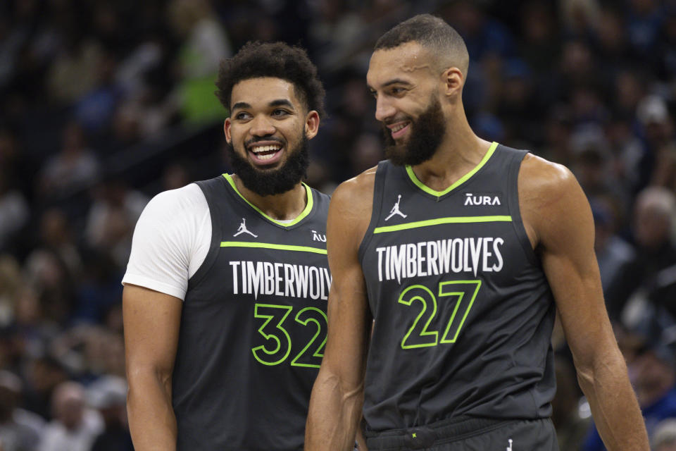 Minnesota Timberwolves center Karl-Anthony Towns (32) and Minnesota Timberwolves center Rudy Gobert (27) walk on the court during the second half of an NBA basketball game against the Dallas Mavericks, Wednesday, Jan. 31, 2024, in Minneapolis. (AP Photo/Bailey Hillesheim)