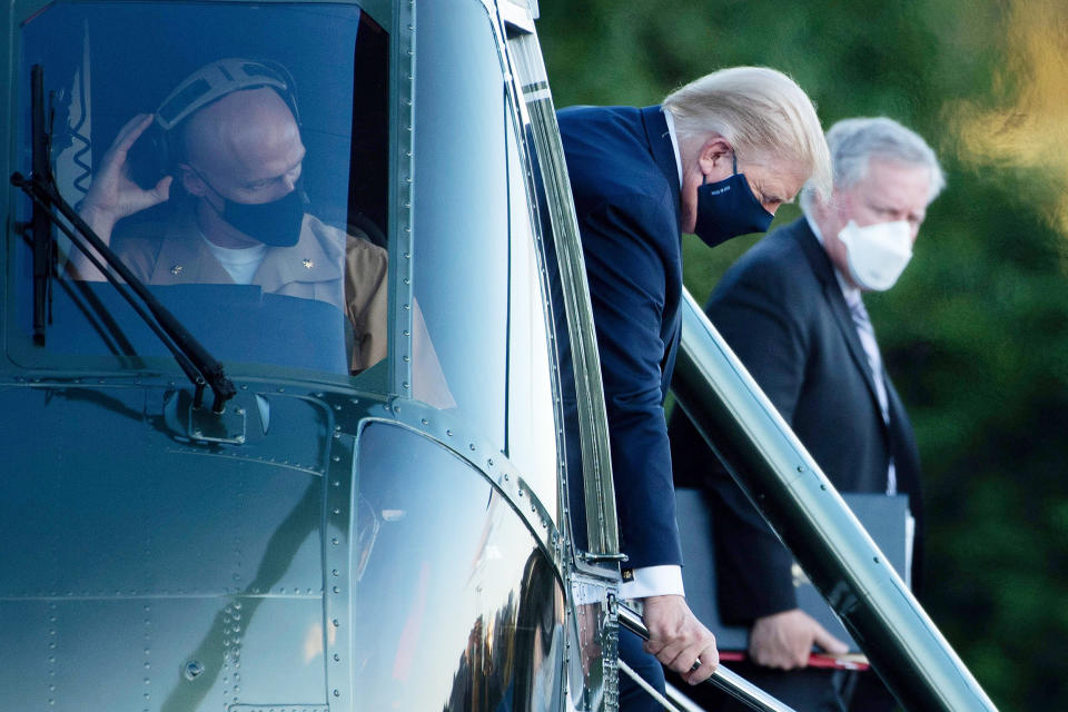 Image: President Donald Trump walks off Marine One while arriving at Walter Reed Medical Center in Bethesda, Md. on Oct. 2, 2020. (Brandan Smialowski / AFP - Getty Images file)