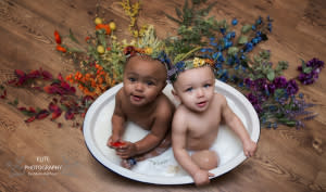 Jarani and Kalani in a milk bath with rainbow flowers to represent their lost brother