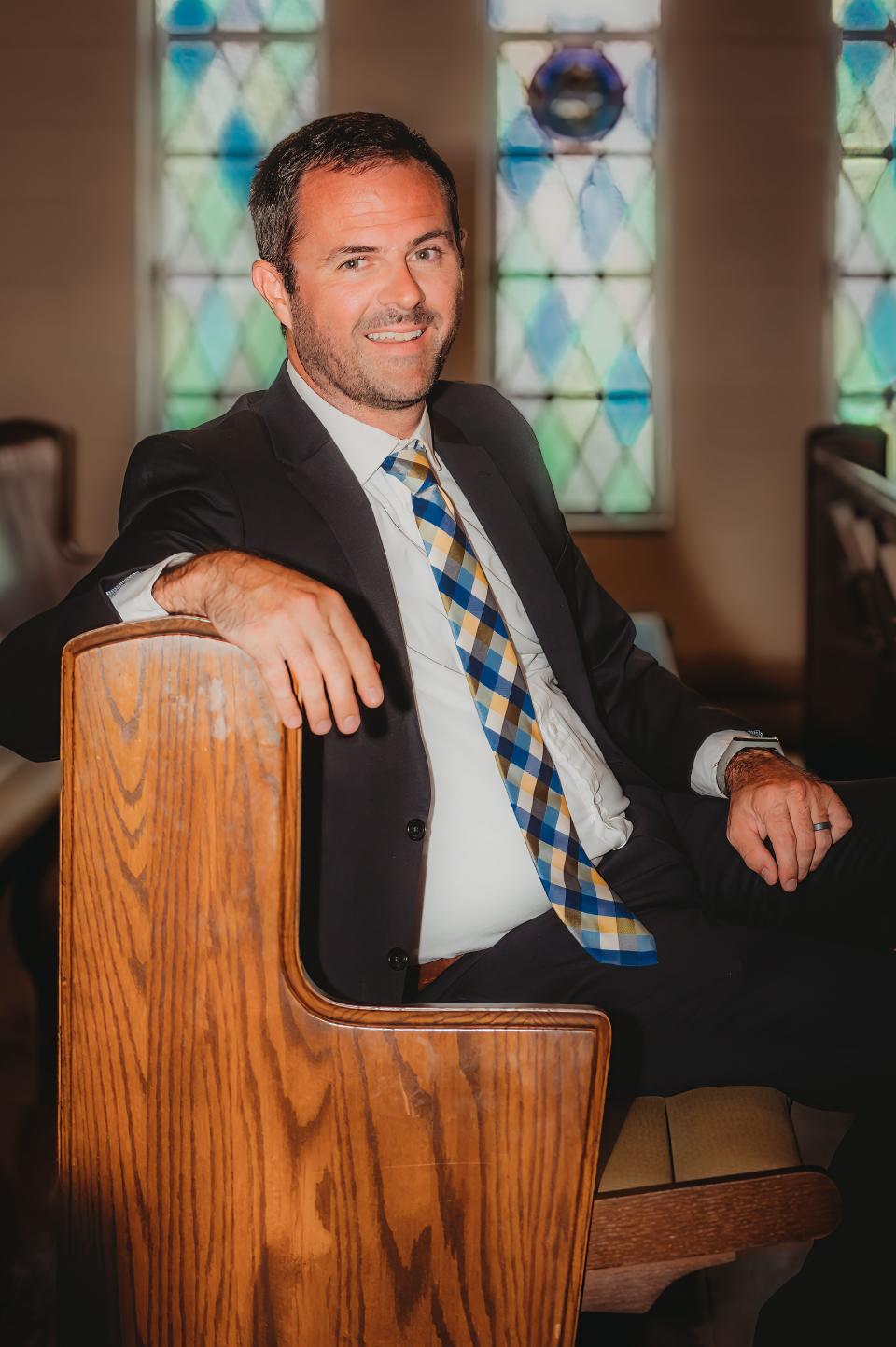 Ryan P. Burge, a political scientist, researcher and pastor, sits in his church in Mount Vernon, Illinois.