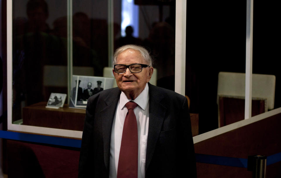 FILE - In this Monday, Dec. 12, 2011 file photo, Israeli Rafi Eitan, right, stands next to a showcase during an opening of an exhibition about Eichmann's capture at the Knesset, Israel's parliament in Jerusalem. Eitan, a legendary Israeli Mossad spy who led the capture of Holocaust mastermind Adolf Eichmann, has died. He was 92. (AP Photo/Sebastian Scheiner)