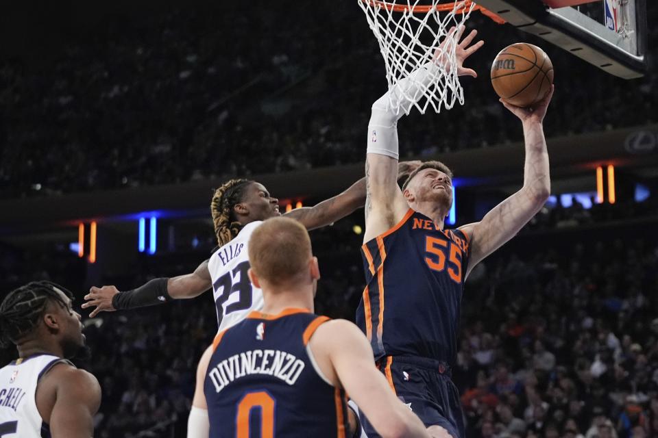 New York Knicks' Isaiah Hartenstein (55) drives past Sacramento Kings' Keon Ellis (23) during the first half of an NBA basketball game Thursday, April 4, 2024, in New York. (AP Photo/Frank Franklin II)