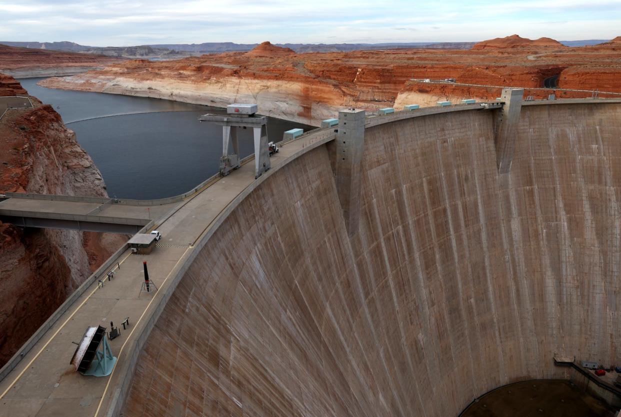 <span class="caption">Lake Powell's water level has been falling amid a two-decade drought. The white 'bathtub ring' on the canyon walls marks the decline.</span> <span class="attribution"><a class="link " href="https://www.gettyimages.com/detail/news-photo/view-of-the-glen-canyon-dam-at-lake-powell-on-march-27-2022-news-photo/1388101365?adppopup=true" rel="nofollow noopener" target="_blank" data-ylk="slk:Justin Sullivan/Getty Images;elm:context_link;itc:0;sec:content-canvas">Justin Sullivan/Getty Images</a></span>