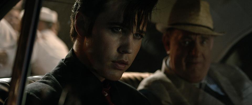 Austin Butler (left) plays young Elvis Presley and Tom Hanks is his manager, Colonel Tom Parker, in Baz Luhrmann's music drama "Elvis."