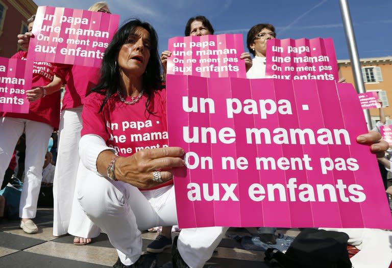 People wave posters reading "A dad, a mum, we don't lie to children" during a demonstration against gay marriage and adoption by same-sex couples on October 24, 2012 in Nice, France. Passions and tensions are rising in France ahead of an expected giant weekend rally against the government's plan to legalise same-sex marriage and adoption that has angered influential Catholic and Muslim groups