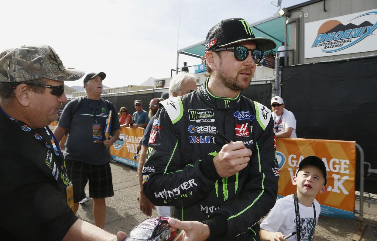 Kurt Busch signs autographs prior to a NASCAR Cup Series auto race at Phoenix International Raceway Sunday, Nov. 12, 2017, in Avondale, Ariz. (AP Photo/Ross D. Franklin)