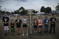 Young motorcycle and APV racers pose with their trophies at the Perry State Fair in New Lexington, Ohio, Friday, July 24, 2020. (AP Photo/Wong Maye-E)