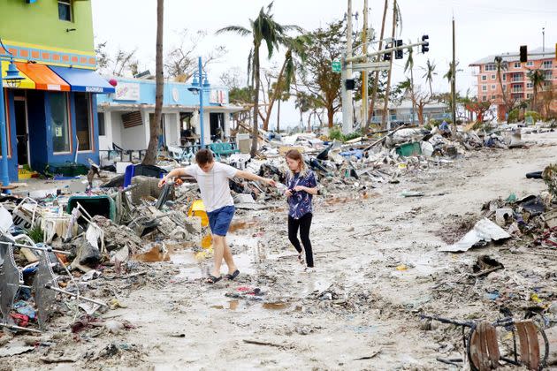 Jake Moses, 19, and Heather Jones, 18, of Fort Myers, explore a section of destroyed businesses at Fort Myers Beach on Sept. 29. (Photo: Douglas R. Clifford/Tampa Bay Times/AP)