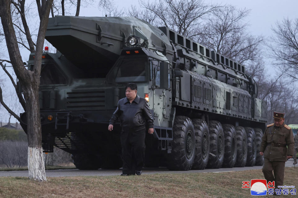 In this photo provided by the North Korean government, North Korean leader Kim Jong Un, center, walks by what they call an intermediate-range ballistic missile on the outskirts of Pyongyang, North Korea Tuesday, April 2, 2024. Independent journalists were not given access to cover the event depicted in this image distributed by the North Korean government. The content of this image is as provided and cannot be independently verified. Korean language watermark on image as provided by source reads: "KCNA" which is the abbreviation for Korean Central News Agency. (Korean Central News Agency/Korea News Service via AP)