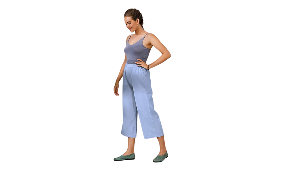 Model wearing Ecupper linen pants, tank top, and flats.