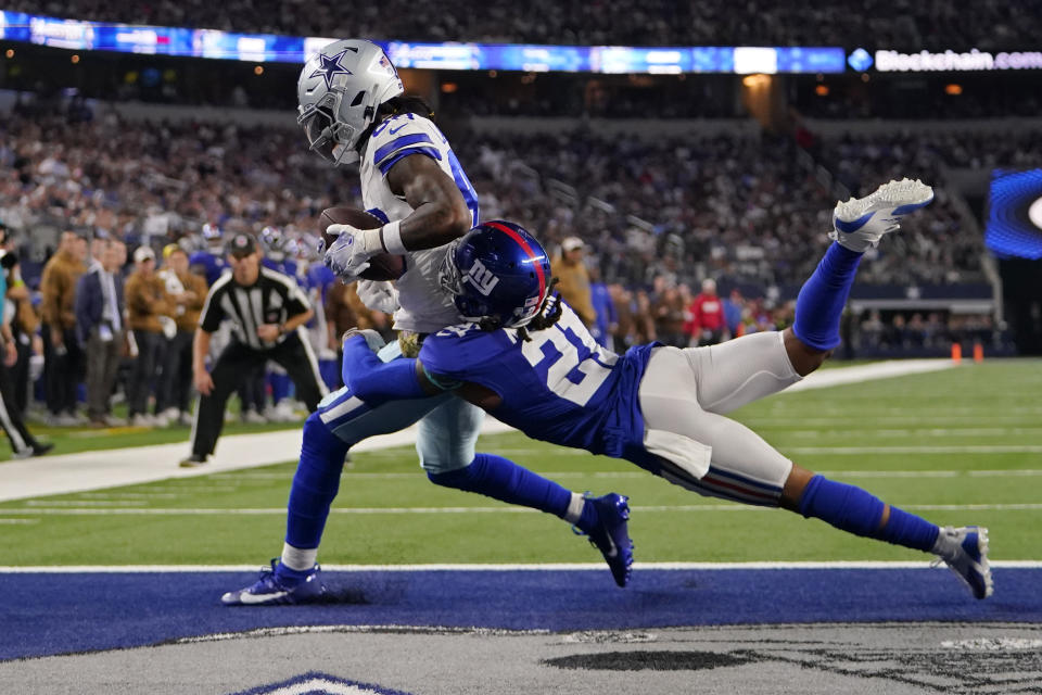 Dallas Cowboys wide receiver CeeDee Lamb, left, is hit by New York Giants safety Bobby McCain (21) after catching a pass for a touchdown in the second half of an NFL football game, Sunday, Nov. 12, 2023, in Arlington, Texas. (AP Photo/Julio Cortez)