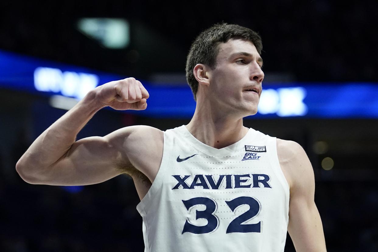Xavier forward Zach Freemantle (32) reacts after scoring during the first half of an NCAA college basketball game against St. John's, Wednesday, Feb. 16, 2022, in Cincinnati.