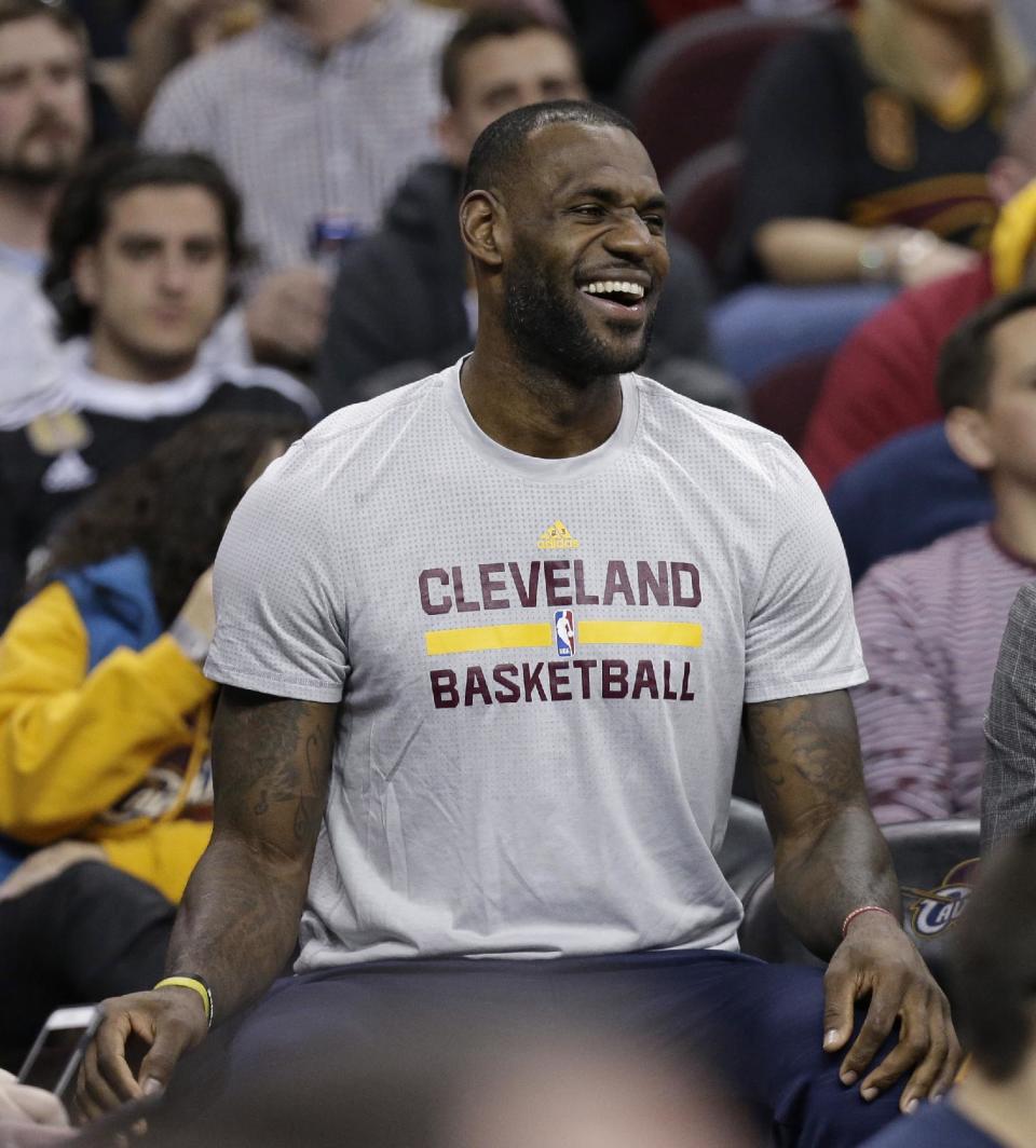 Cleveland Cavaliers&#39; LeBron James laughs as he sits on the bench in the first half of an NBA basketball game against the Dallas Mavericks, Wednesday, March 16, 2016, in Cleveland. The Cavaliers are using a pit stop at home to give LeBron James some rest. James is sitting out the game against Dallas, part of coach Tyronn Lue&#39;s plans to give him some time off before the NBA playoffs begin next month. (AP Photo/Tony Dejak)