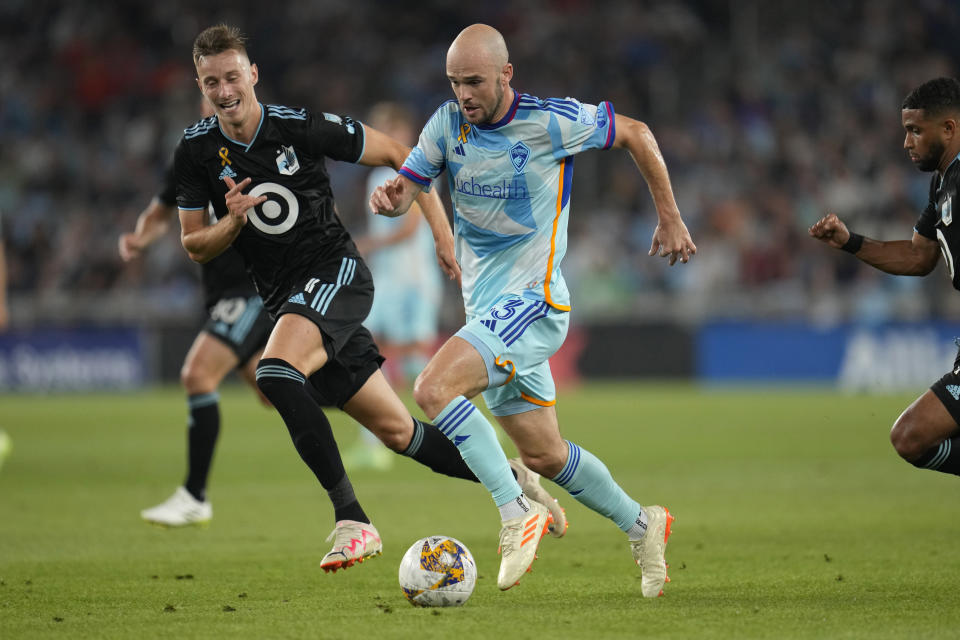 Colorado Rapids defender Andrew Gutman, center, controls the ball during the first half of an MLS soccer match against Minnesota United, Wednesday, Aug. 30, 2023, in St. Paul, Minn. (AP Photo/Abbie Parr)