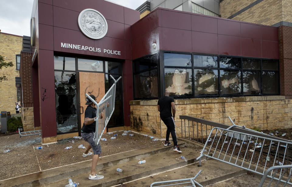 Protesters damage properties at the Minneapolis 3rd Police Precinct in Minneapolis on Wednesday, May 27, 2020. The mayor of Minneapolis called Wednesday for criminal charges against the white police officer seen on video kneeling against the neck of a handcuffed black man who complained that he could not breathe and died in police custody. (Carlos Gonzalez/Star Tribune via AP)