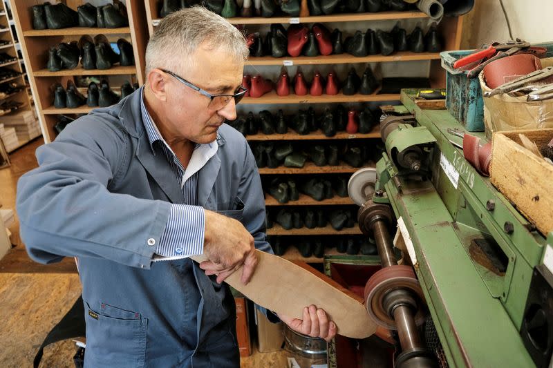 Romanian shoemaker Grigore Lup works on a pair of long-nosed leather shoes, amid the outbreak of the coronavirus disease (COVID-19), in Cluj-Napoca