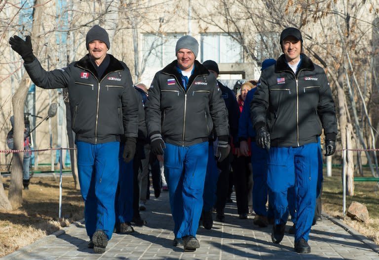 Image provided by NASA shows astronauts (L-R) Chris Hadfield, Roman Romanenko and Tom Marshburn ahead of their space launch to the ISS on December 19, 2012. The three astronauts returned to Earth on Tuesday after a half-year mission aboard the ISS