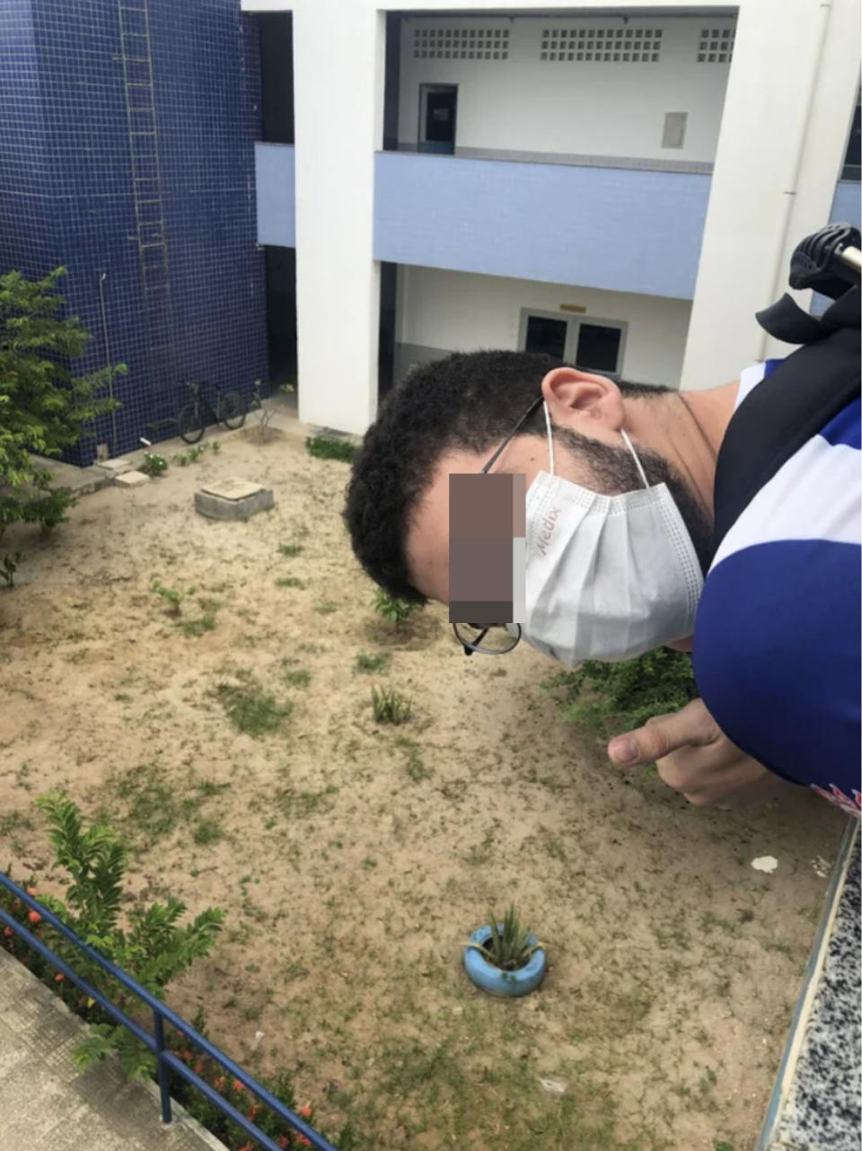 The balcony is apparent up close, with the yard below him