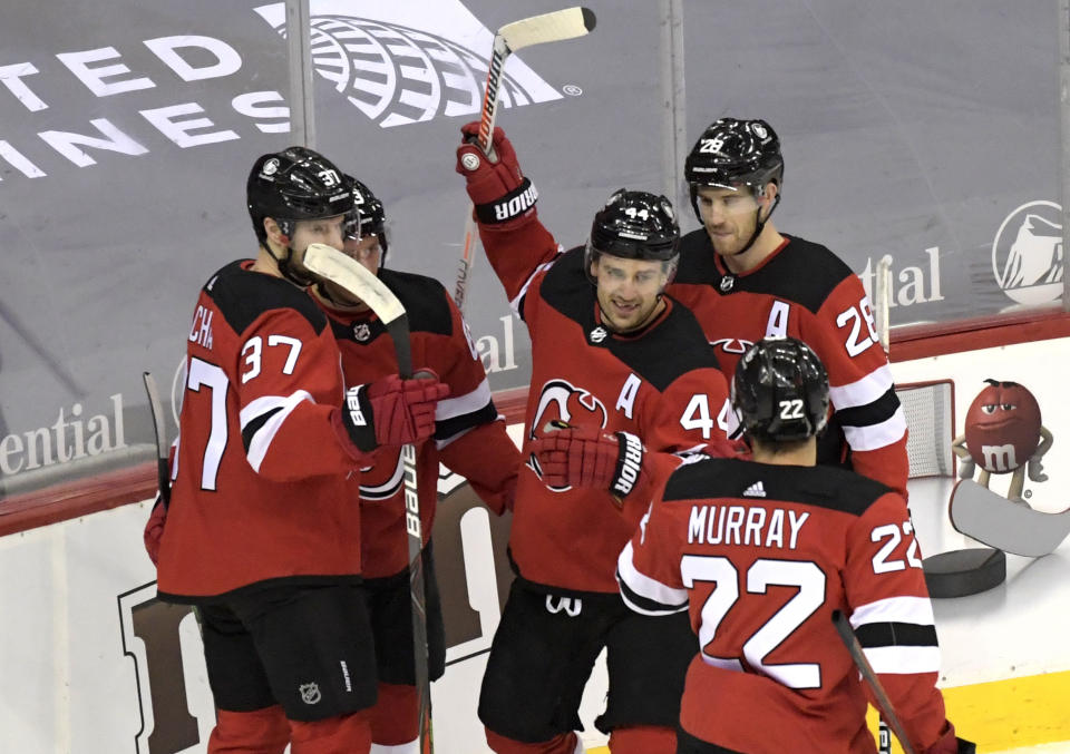 New Jersey Devils left wing Miles Wood (44) celebrates his goal with teammates during the first period of an NHL hockey game against the Pittsburgh Penguins on Friday, April 9, 2021, in Newark, N.J. (AP Photo/Bill Kostroun)