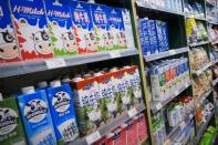 Cartons of milk are displayed on shelves at a supermarket in Beijing