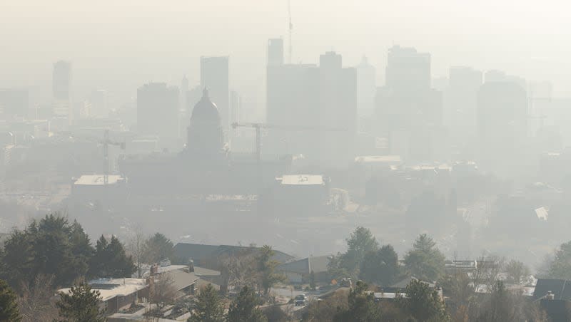 Smog settles over Salt Lake City on Sunday, Dec. 31, 2023. As many as 131.2 million people in the U.S. live where the air quality gets failing grades due to too-high levels of ozone or particle pollution.