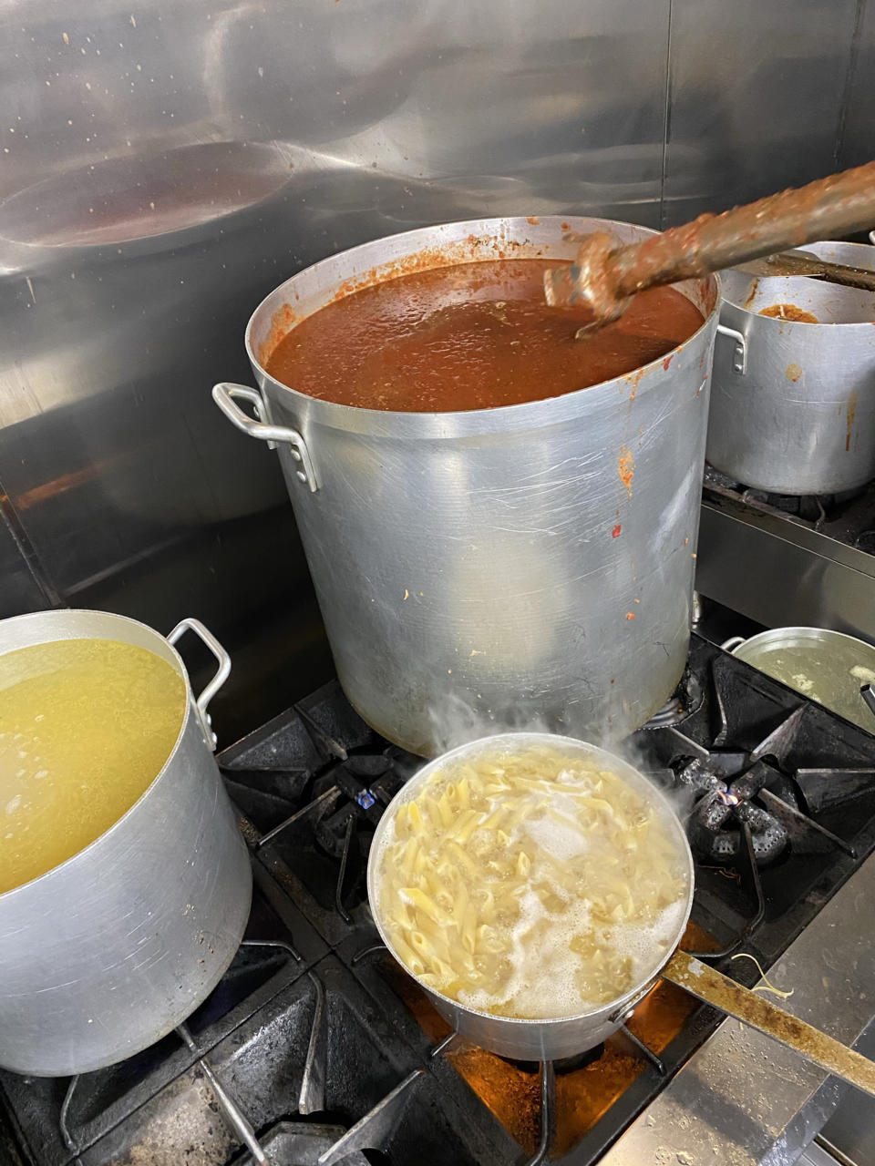 Local residents were grateful for a warm Italian meal after days without power in icy temperatures.  (Ari Isufaj)