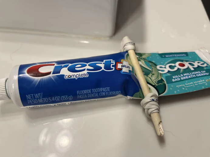 rubber band and stick on a tube of toothpaste