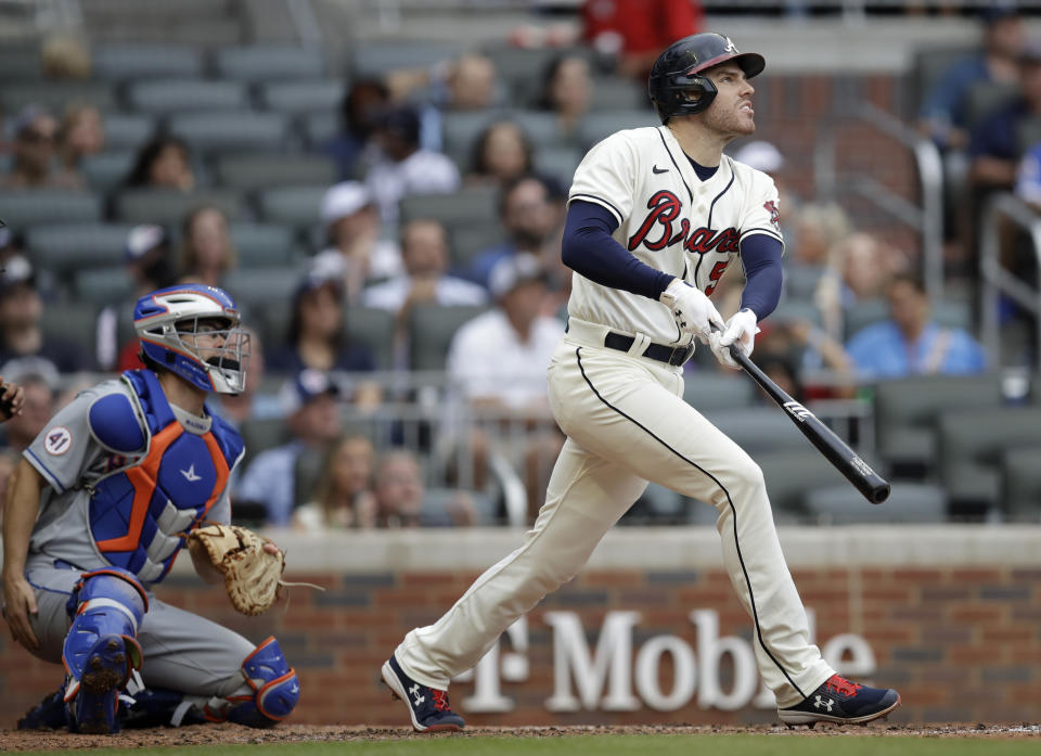 Atlanta Braves' Freddie Freeman eyes a fly ball hit against the New York Mets during a baseball game Sunday, Oct. 3, 2021, in Atlanta. (AP Photo/Ben Margot)