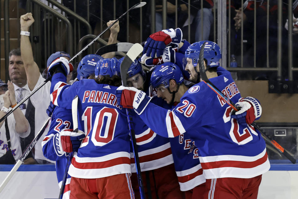 New York Rangers' Mika Zibanejad is congratulated by teammates after scoring a goal against the Carolina Hurricanes in Game 3 of an NHL hockey Stanley Cup second-round playoff series, Sunday, May 22, 2022, in New York. (AP Photo/Adam Hunger)