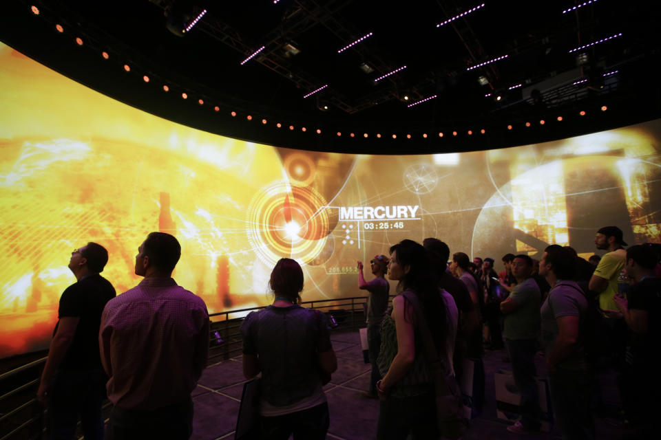 Show attendees watch a presentation on the video game "Destiny" at the Activision Blizzard Booth during the Electronic Entertainment Expo in Los Angeles, Thursday, June 13, 2013. (AP Photo/Jae C. Hong)